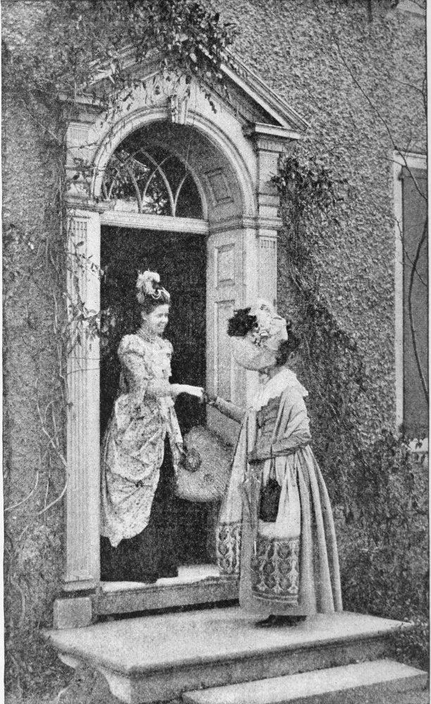 One woman greeting another woman on the doorstep